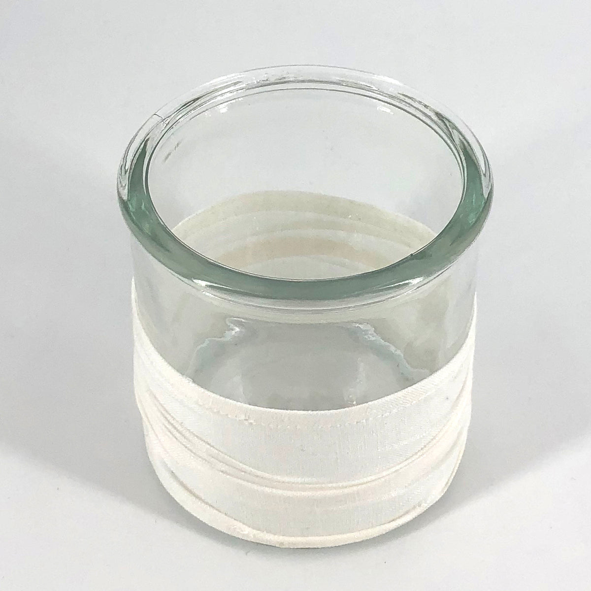 Windlicht aus Glas, mit Stoffbezug